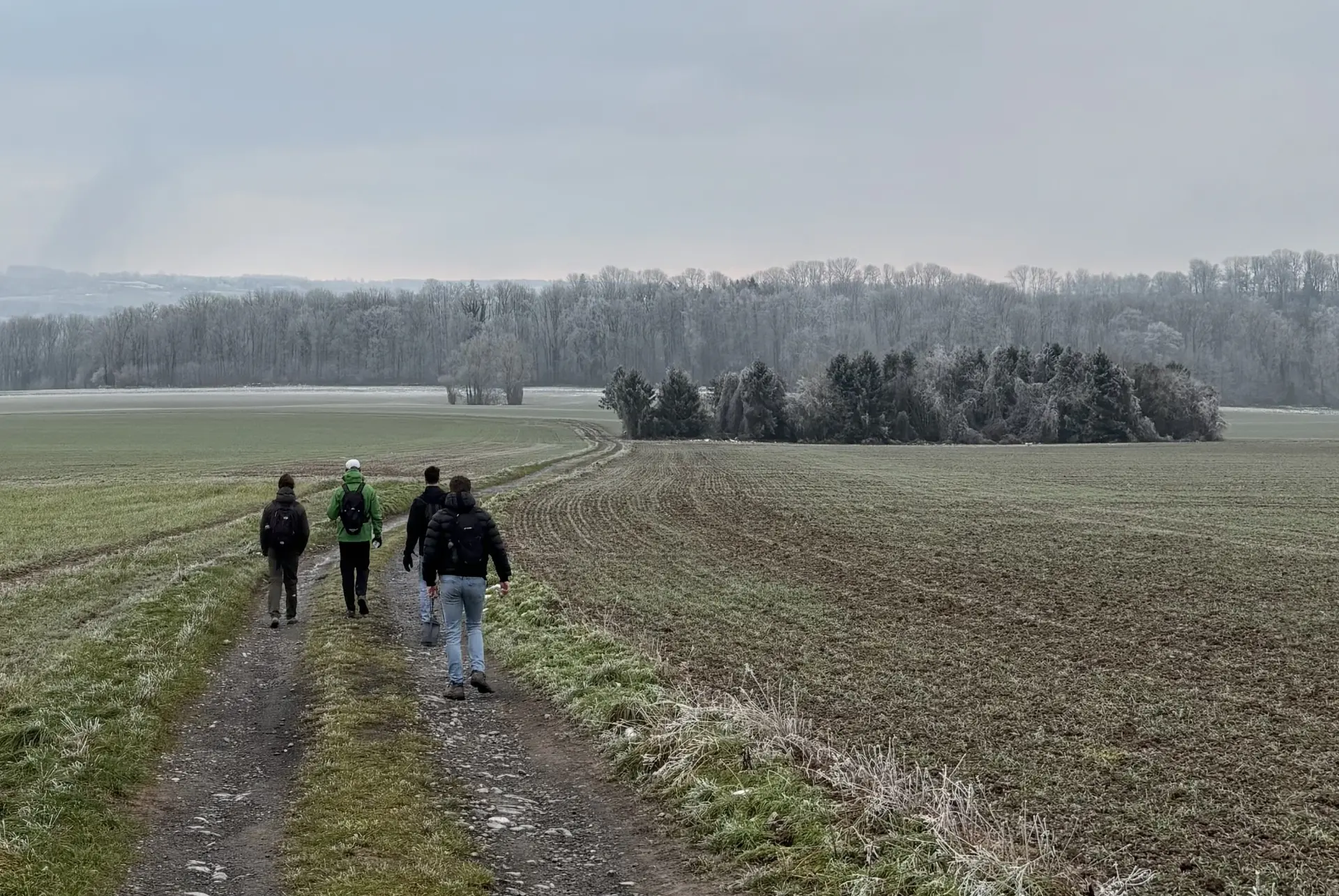 A group of men walking a path through open fields on The Quest of Tomorrow